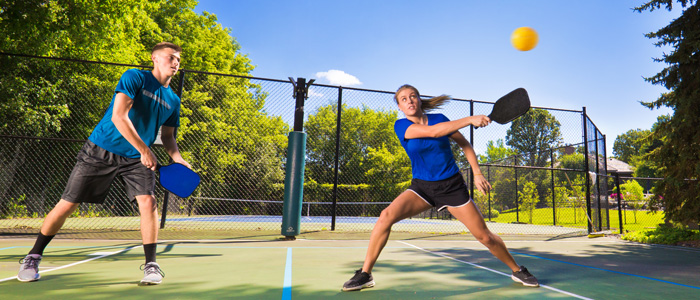 a man and a woman playing pickleball